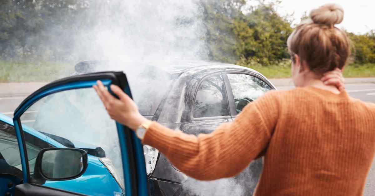 Woman rubs her neck after a car accident.